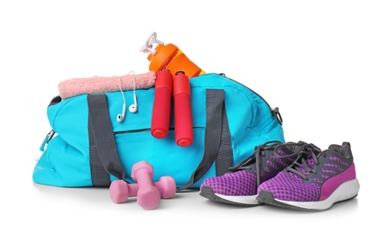 Sports bag and gym equipment on white background