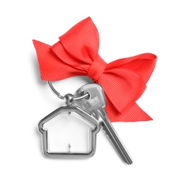 House key with trinket and bow on white background, top view