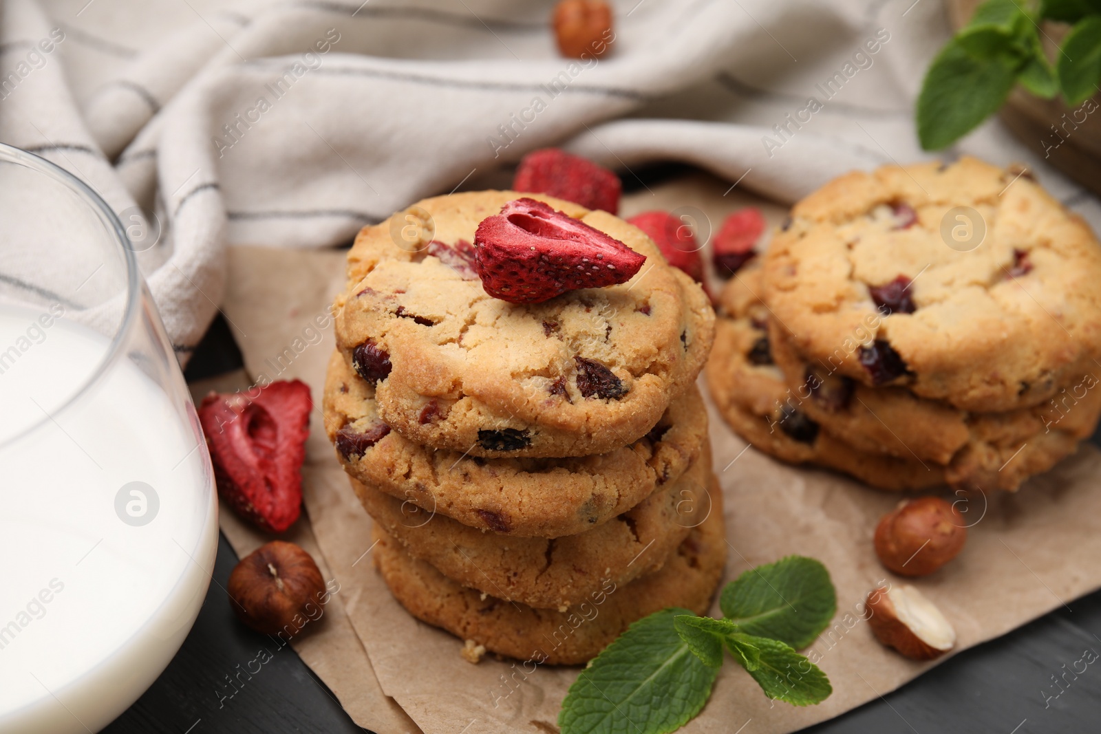 Cookies with freeze dried fruits, mint, milk and nuts on grey table, closeup Photo of Cookies with freeze dried fruits, mint, milk and nuts on grey table, closeup