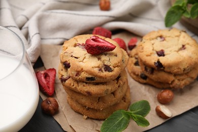 Photo of Cookies with freeze dried fruits, mint, milk and nuts on grey table, closeup