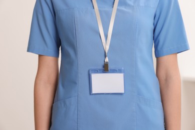 Photo of Doctor with blank badge in hospital, closeup
