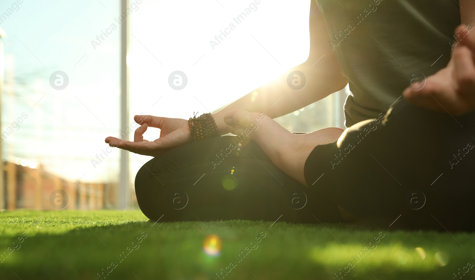 Photo of Young woman practicing yoga in sunlit room, closeup