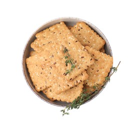 Photo of Cereal crackers with flax, sesame seeds and thyme in bowl isolated on white, top view