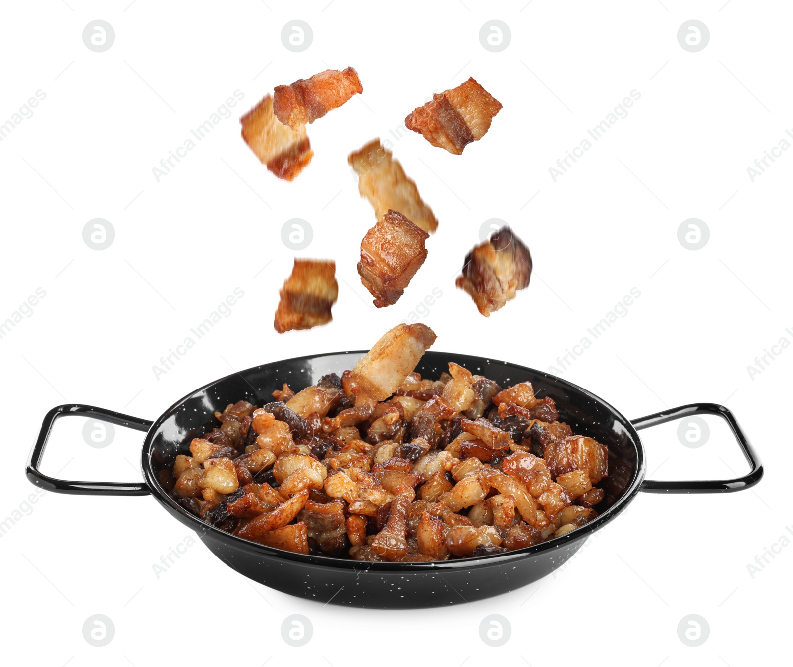 Image of Tasty cracklings falling into frying pan on white background. Cooked pork lard