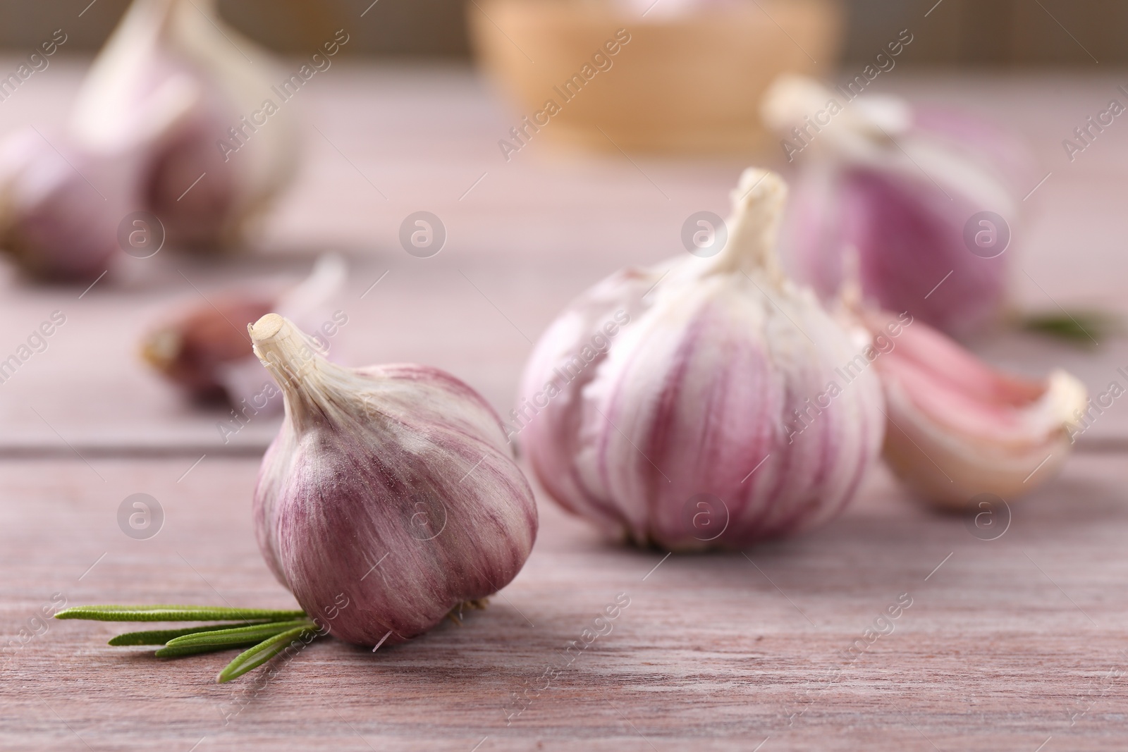 Photo of Bulbs of fresh garlic on wooden table, selective focus