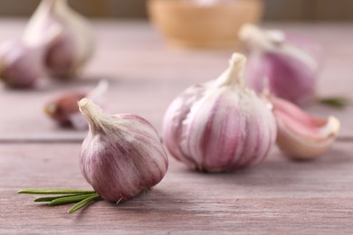 Bulbs of fresh garlic on wooden table, selective focus