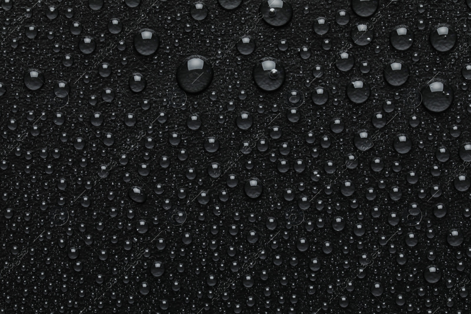 Photo of Water drops on black background, top view