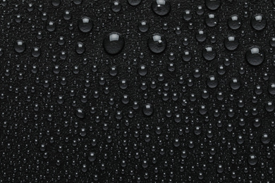 Photo of Water drops on black background, top view