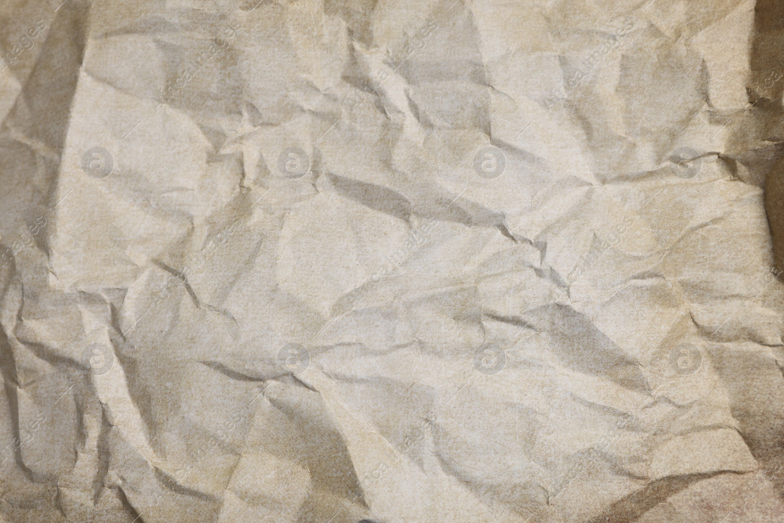 Photo of Texture of crumpled parchment paper as background, top view