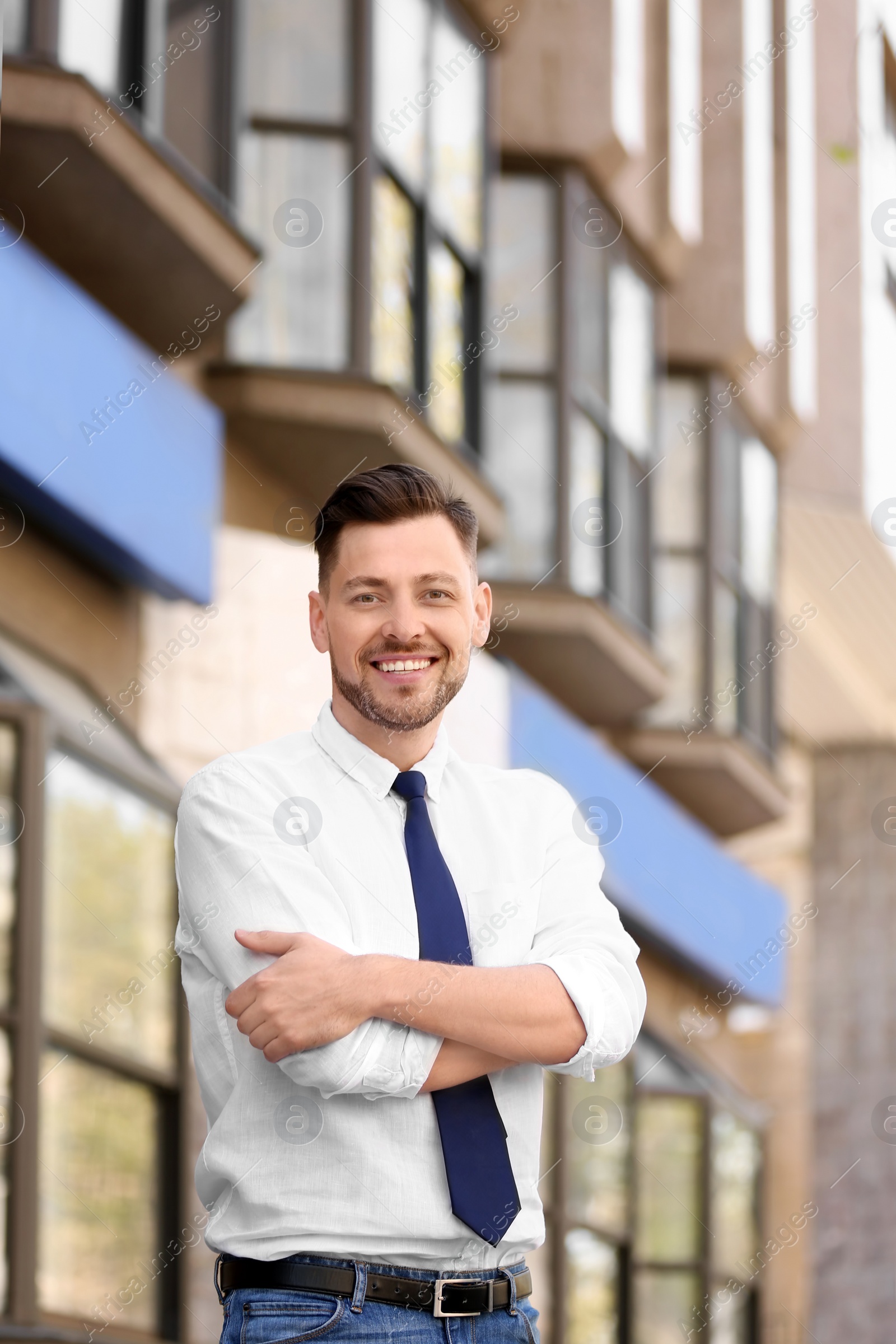 Photo of Portrait of young businessman in stylish outfit outdoors