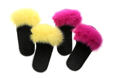 Photo of Soft open toe slippers with yellow and pink fur on white background, top view