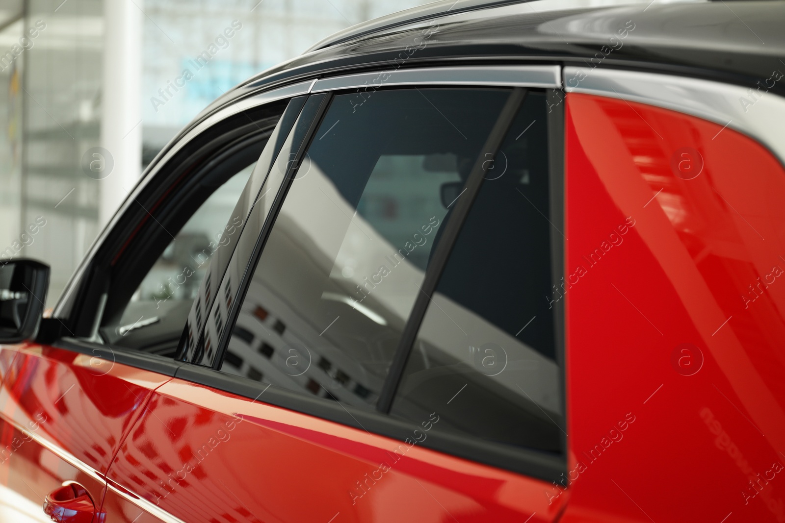 Photo of Modern car with tinting foil on window, closeup