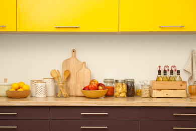 Stylish kitchen interior with wooden countertop and wall cabinets