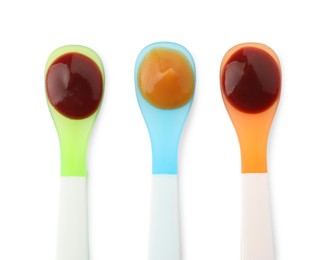 Photo of Healthy baby food in spoons on white background, top view