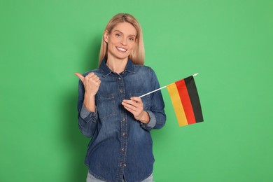 Photo of Woman with flag of Germany on green background