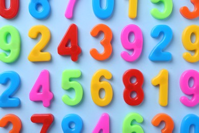 Photo of Colorful numbers on blue background, flat lay