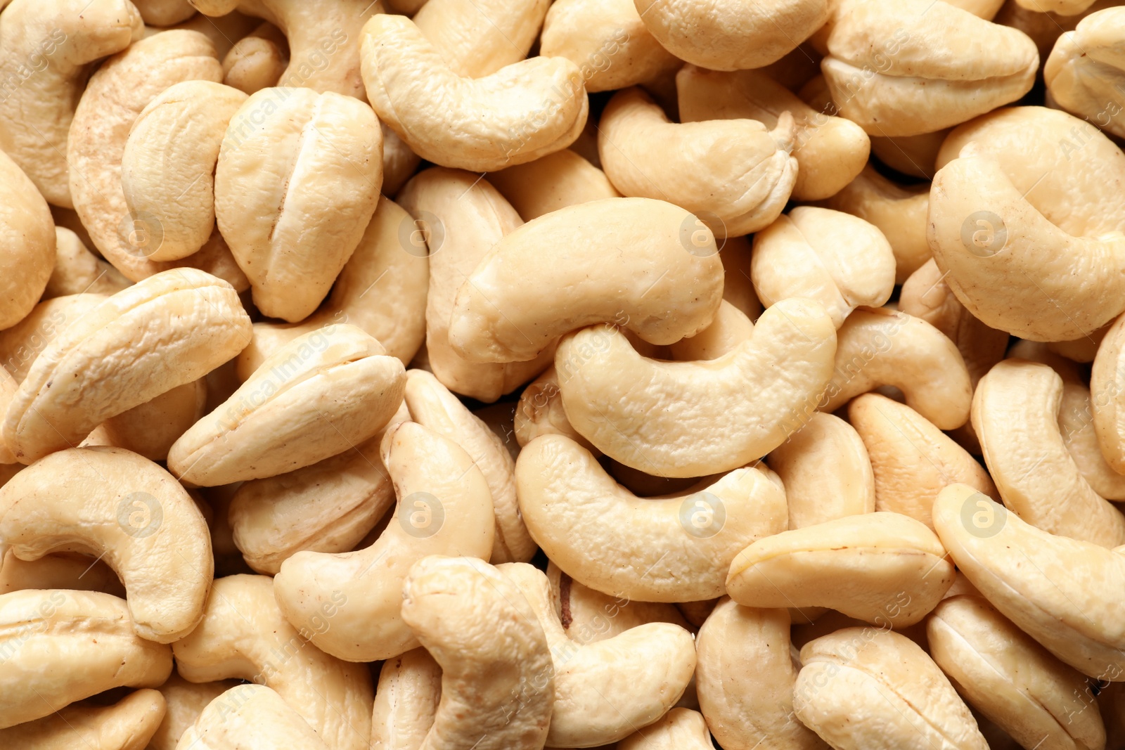 Photo of Tasty cashew nuts as background, top view