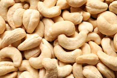 Tasty cashew nuts as background, top view