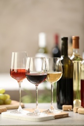 Photo of Different glasses with wine served on table. Space for text