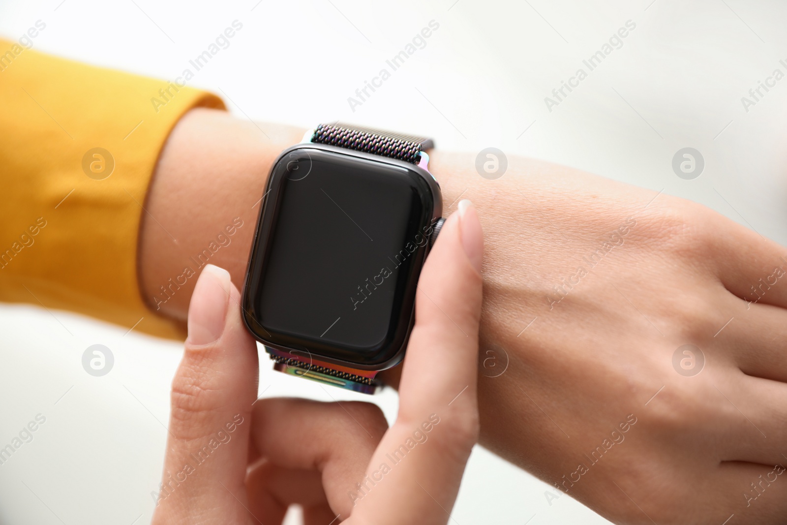 Image of Woman checking stylish smart watch on white background, closeup