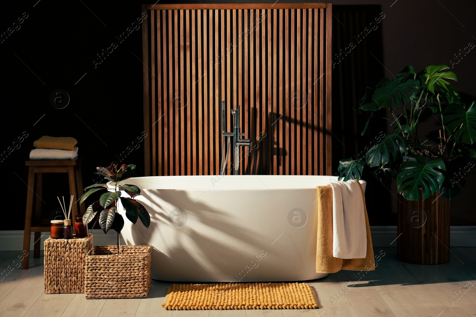 Photo of Cozy bathroom interior with stylish ceramic tub