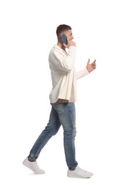 Man talking on smartphone while walking against white background