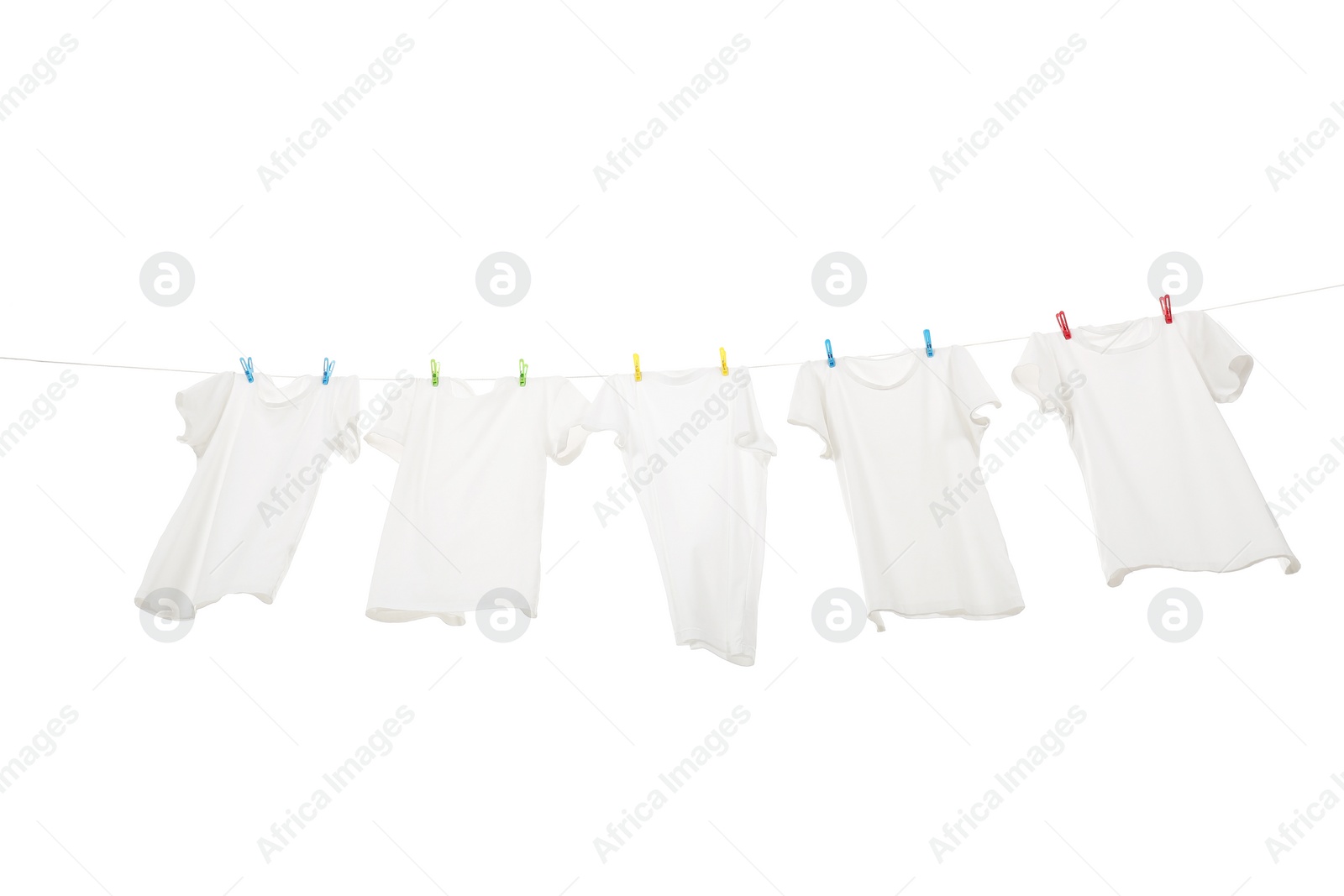 Photo of Many t-shirts drying on washing line isolated on white, low angle view
