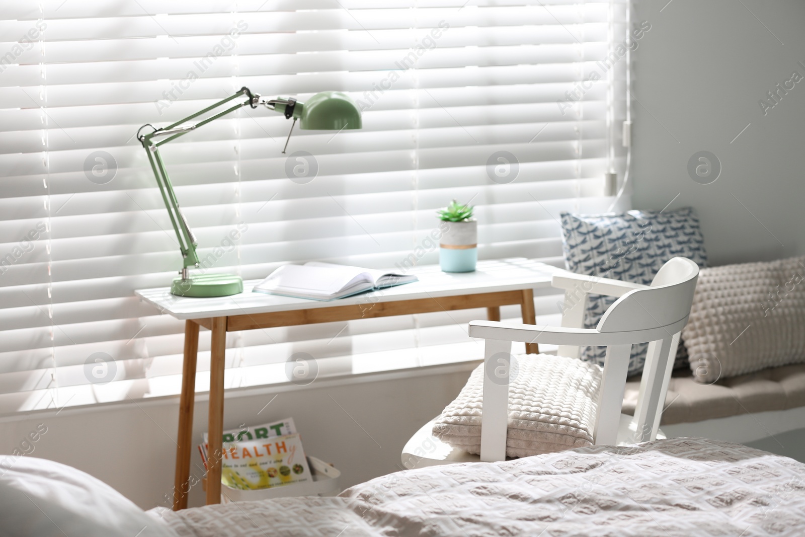 Photo of Comfortable workplace near window in modern bedroom