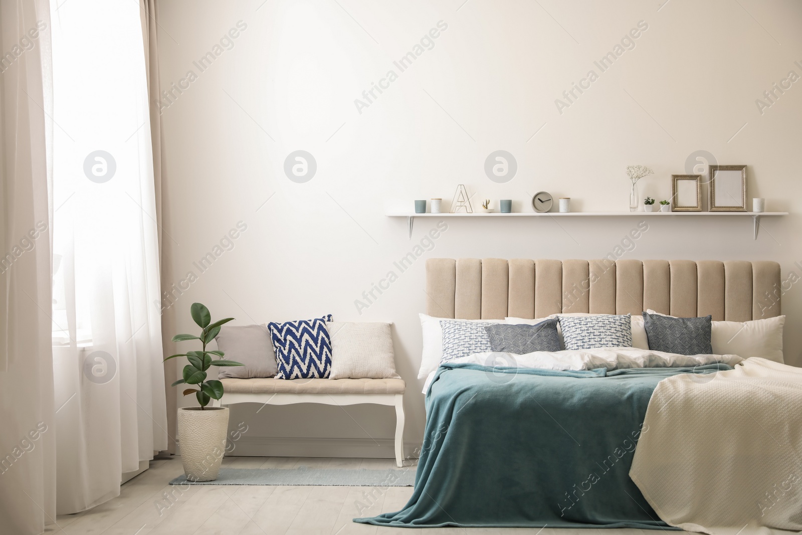 Photo of Comfortable bed with pillows in room. Stylish interior design