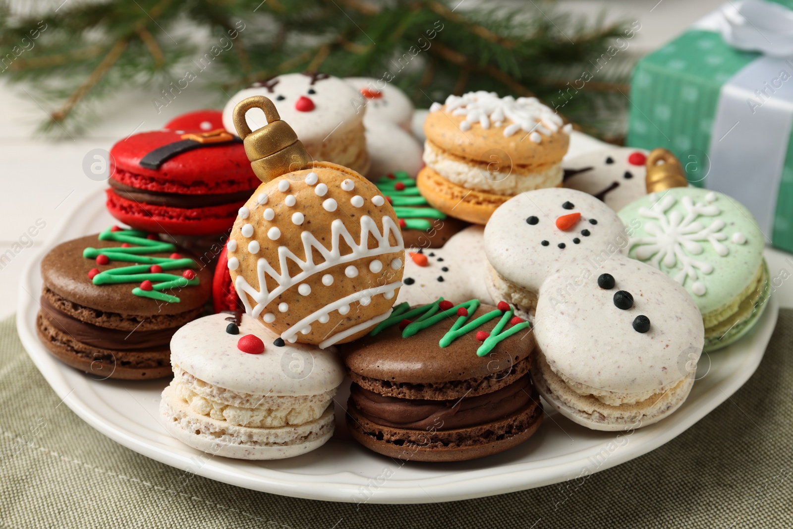 Photo of Beautifully decorated Christmas macarons on table, closeup