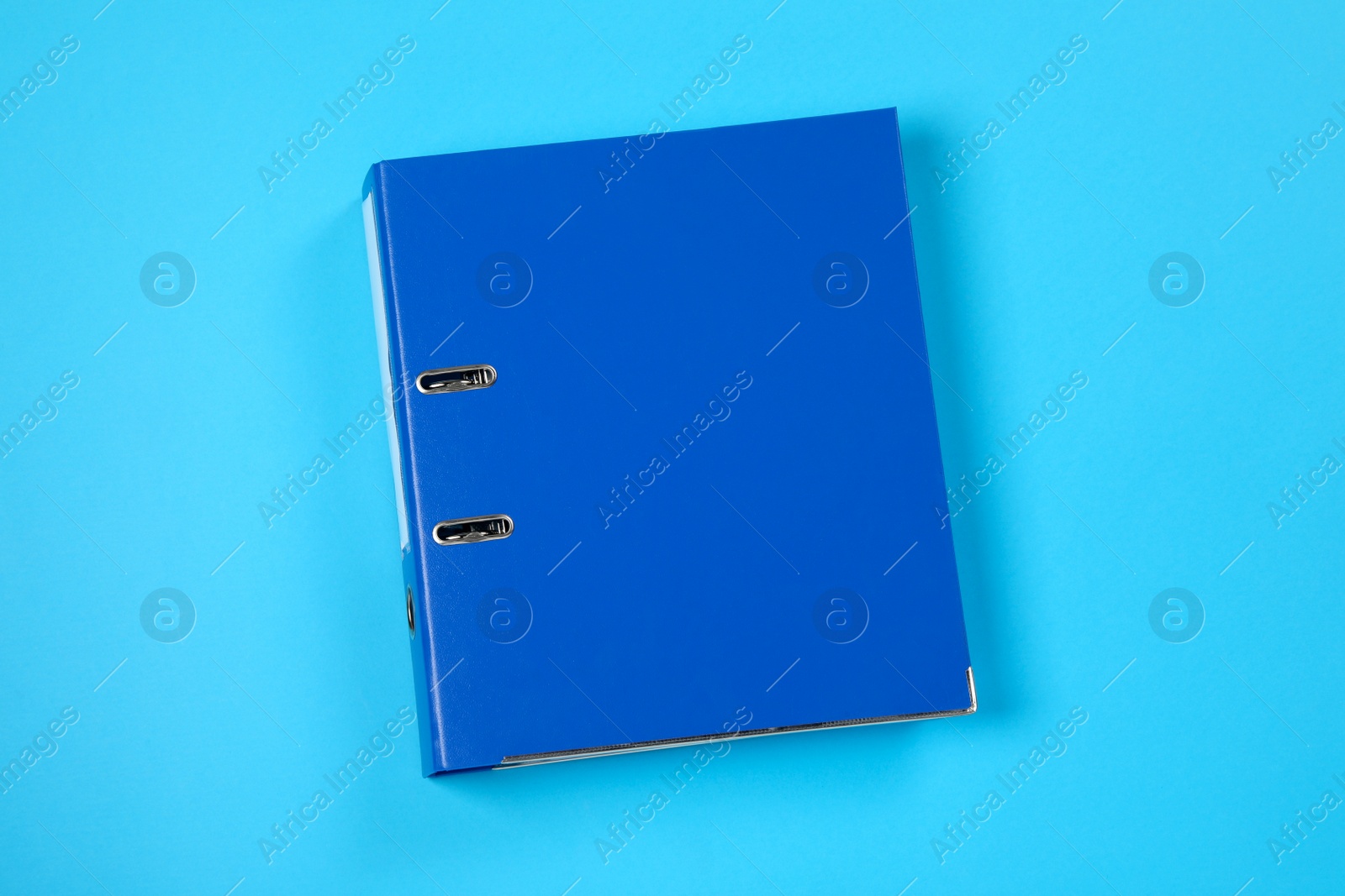 Photo of One office folder on light blue background, top view