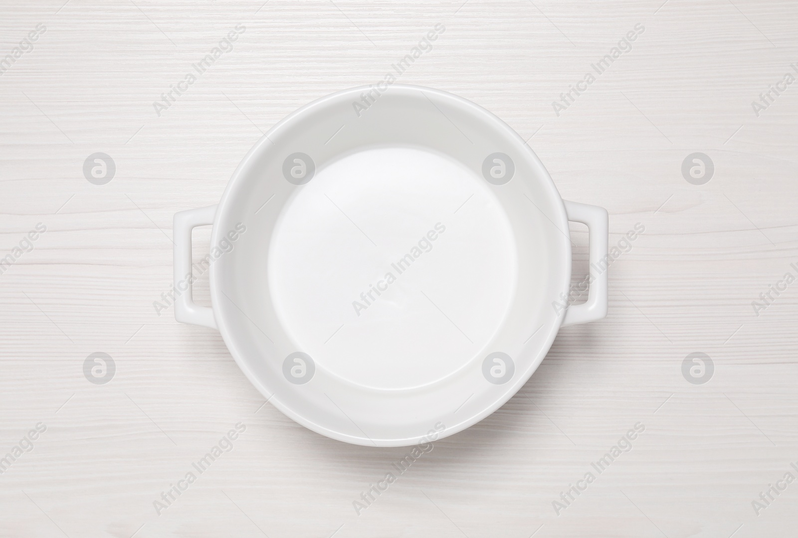Photo of Empty pot on white wooden table, top view