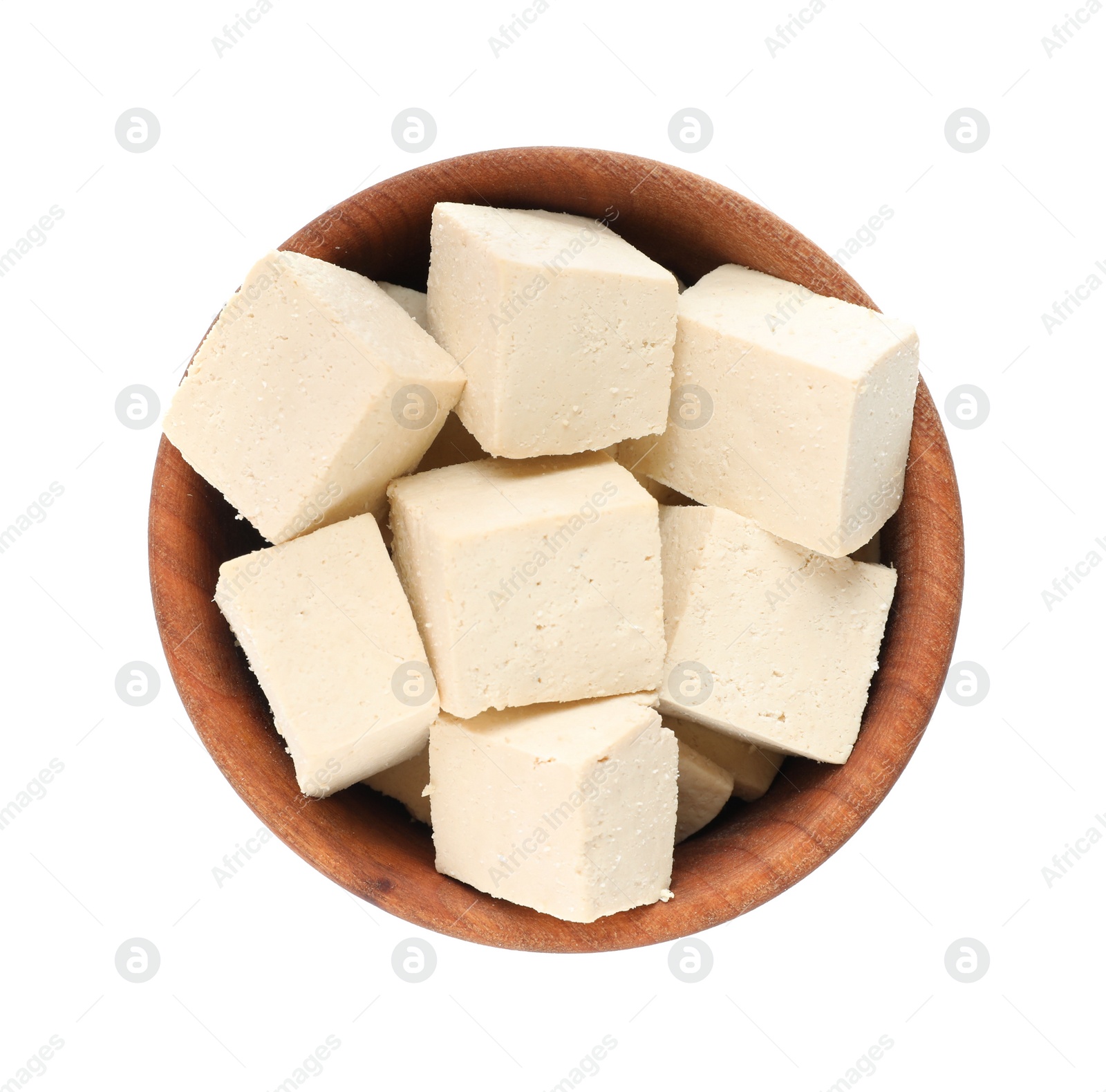 Photo of Wooden bowl with delicious tofu isolated on white, top view