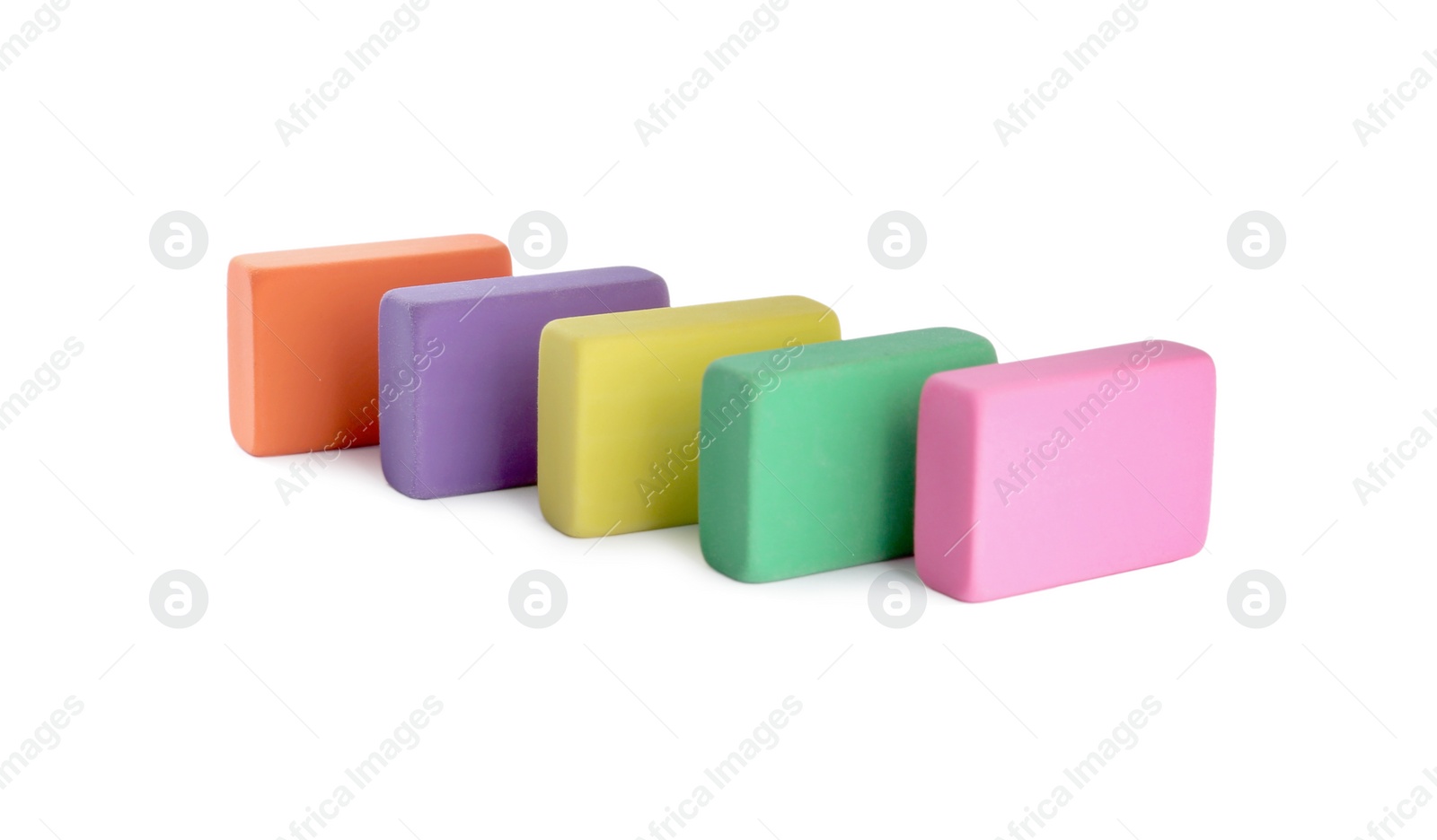 Photo of Row of bright erasers on white background