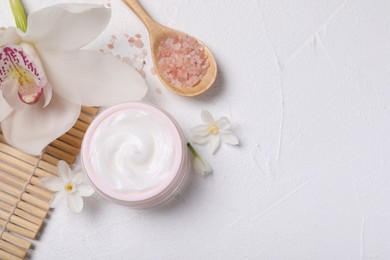 Photo of Beautiful spa composition with cosmetic products and flowers on white table, flat lay. Space for text