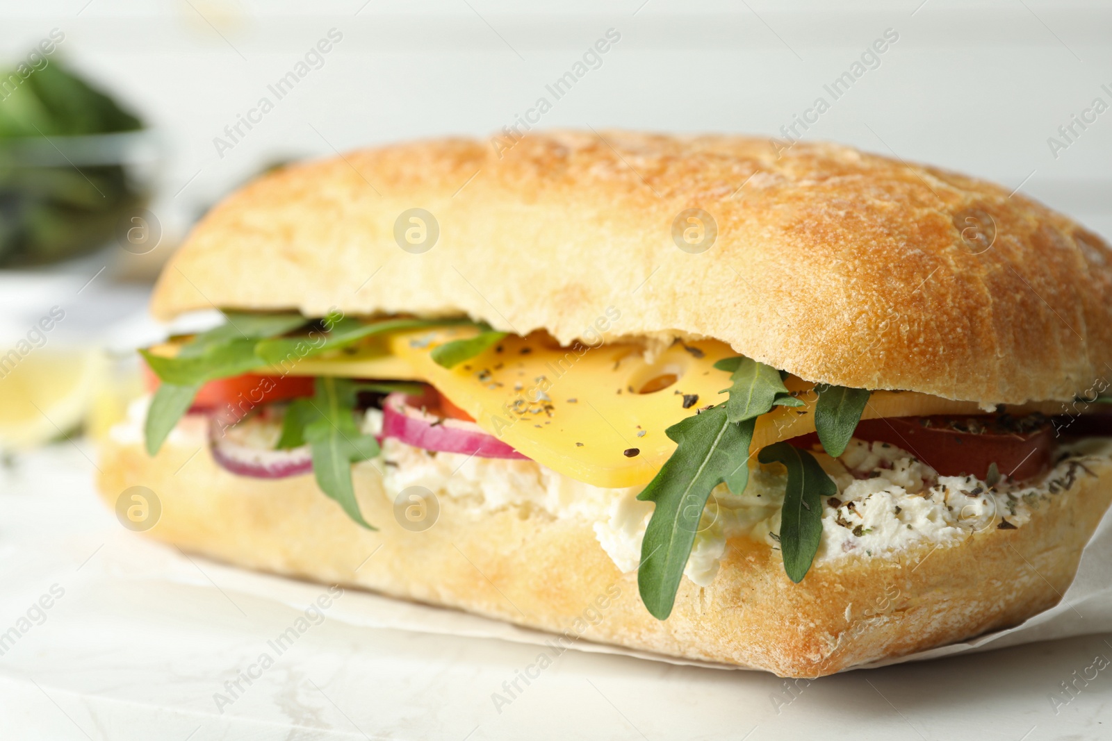 Photo of Delicious sandwich with fresh vegetables and cheese on white table, closeup