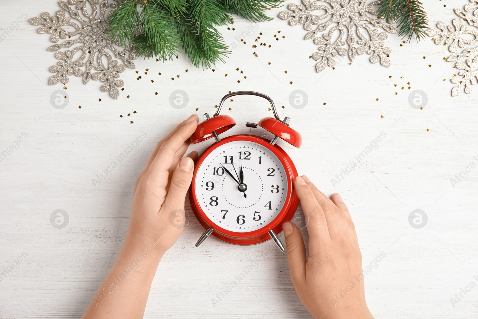 Photo of Woman with alarm clock at table, top view. Christmas countdown