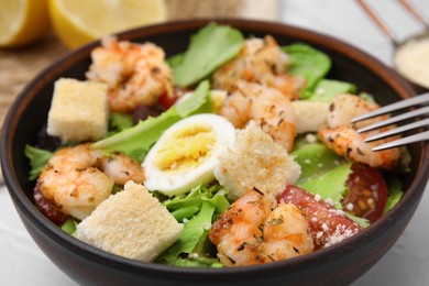 Photo of Delicious Caesar salad with shrimps on table, closeup