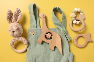 Photo of Different baby accessories on yellow background, flat lay