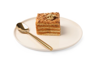 Piece of delicious layered honey cake and spoon on white background