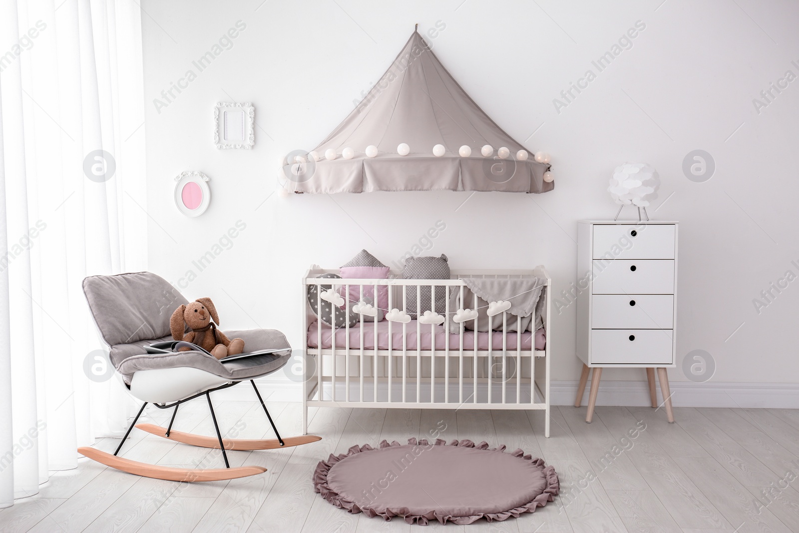 Photo of Interior of baby room with comfortable crib