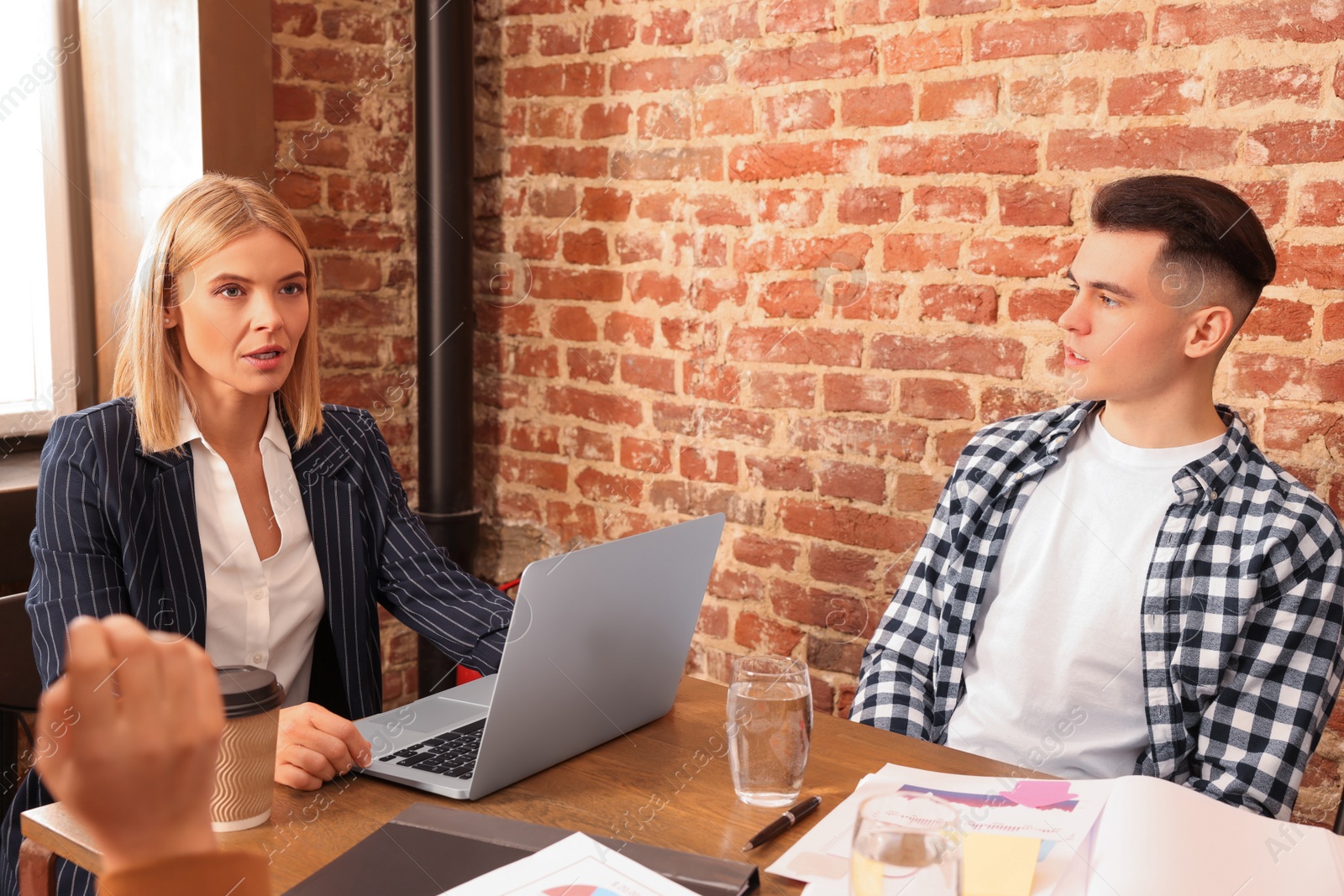 Photo of Businesswoman having meeting with her employees in office. Lady boss