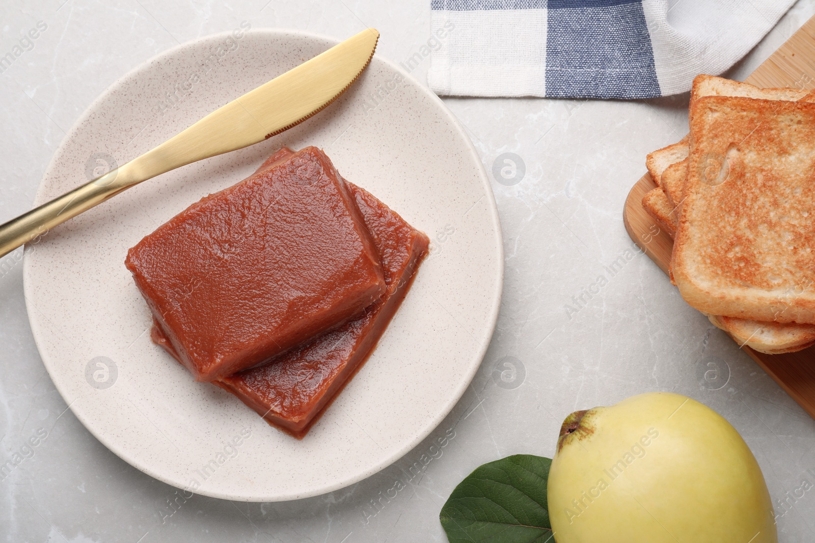 Photo of Flat lay composition with delicious quince paste on white table