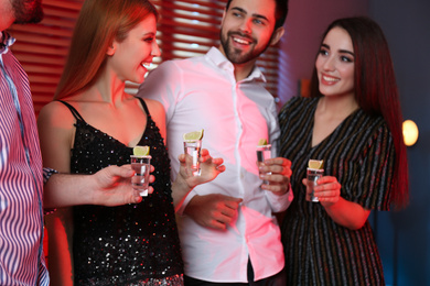 Photo of Young people with Mexican Tequila shots in bar