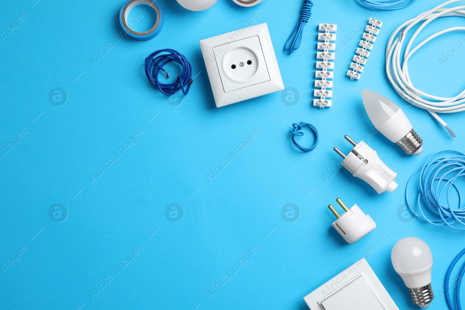 Photo of Flat lay composition with electrician's accessories on light blue background, space for text