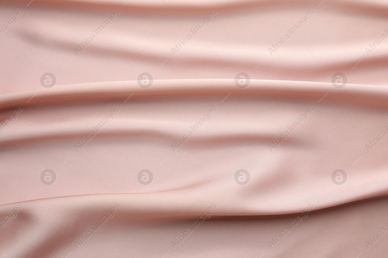 Photo of Crumpled pink silk fabric as background, top view