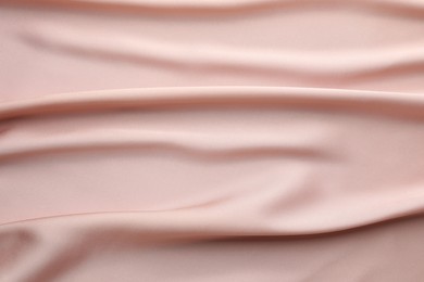 Photo of Crumpled pink silk fabric as background, top view