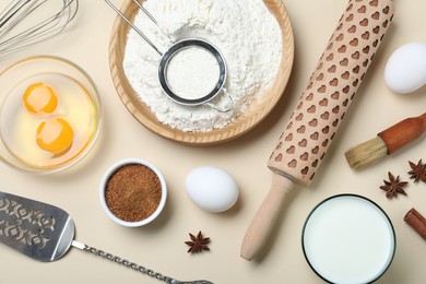 Photo of Cooking utensils and ingredients on beige background, flat lay