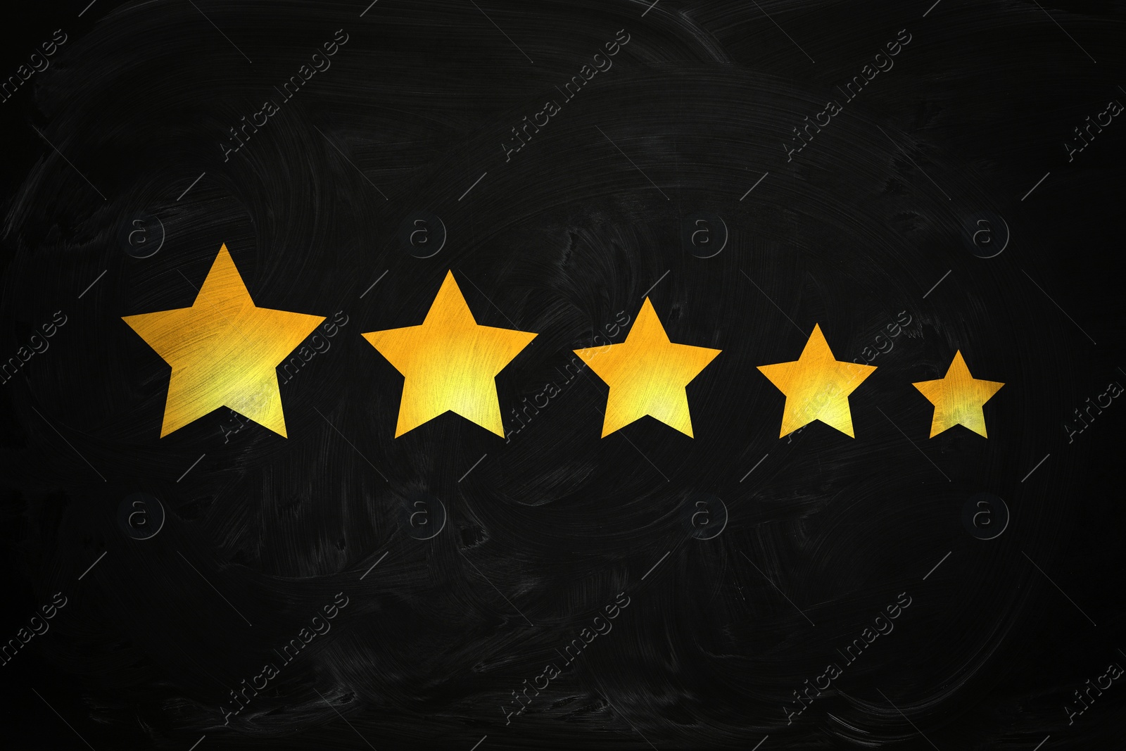 Image of Quality evaluation. Golden stars on black chalkboard