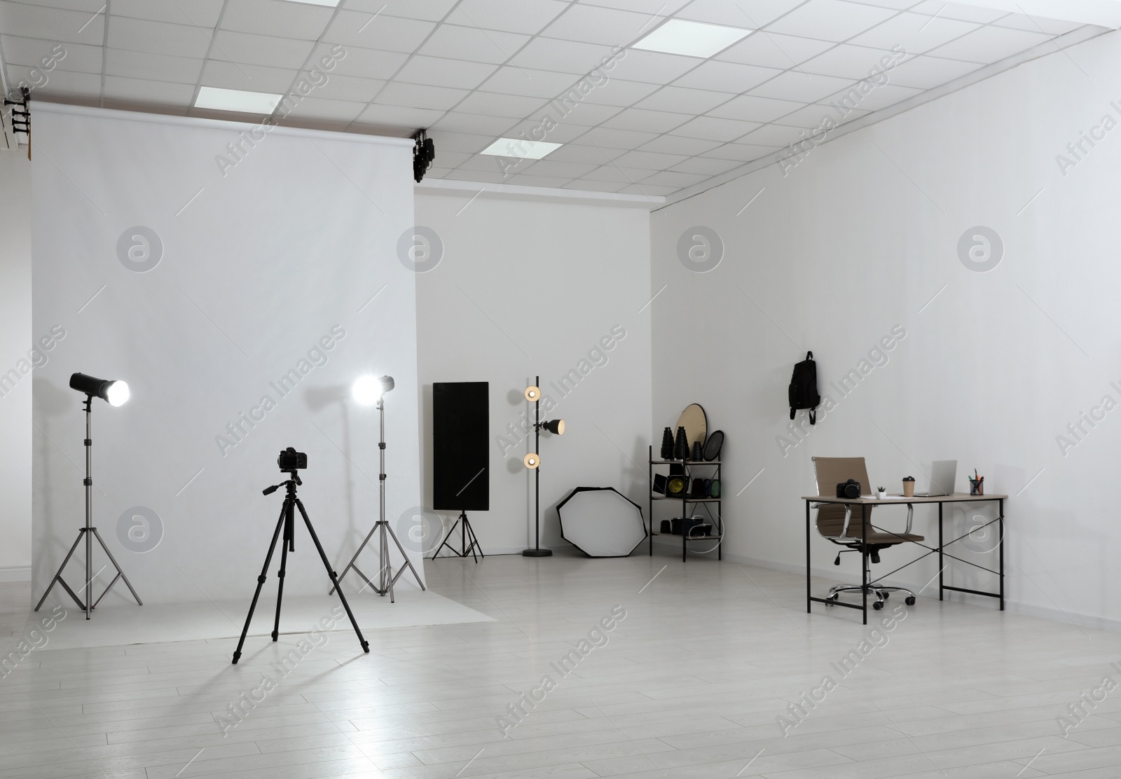 Photo of Photo studio interior with set of professional equipment and workplace